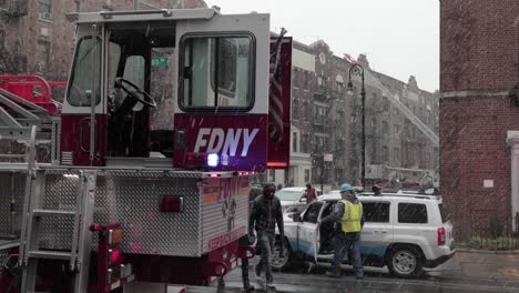 Cabina-De-Dirección-De-Las-Ruedas-Traseras-Del-Camión-De-Bomberos-Fdny-Con-Luces-Intermitentes-Bajo-Una-Nevada---Primer-Plano-Medio