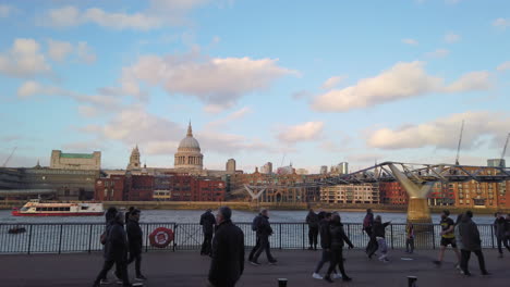 People-walking-past-Millennium-Bridge-Saint-Paul-Cathedral-skyline-in-the-city,-on-the-first-day-after-Brexit