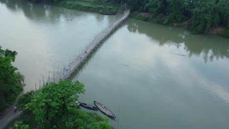 People-use-bicycles-or-bikes-to-travel-on-the-Damodar-Bridge-by-bamboo-or-wooden-bridge