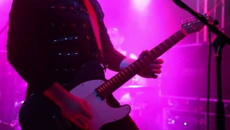 Guitar-Player-Doing-Solo-with-Colorful-Stage-Light-Background,-Close-Up