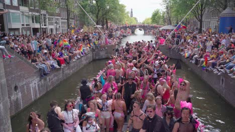 Lgbtq-pride-supporters-dancing-on-boat-in-Amsterdam,-Netherlands-during-Pride-parade