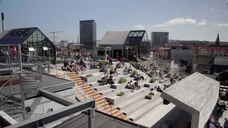 People-enjoying-the-sun-on-salling-rooftop-in-Aarhus-Denmark-4K