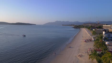 Langkawi-coastline-showing-hotels-and-resorts-on-a-tropical-beach-with-tourists-enjoying-the-clear-blue-water