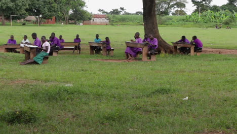 African-school-education-system-outdoor-class-with-black-students-class-taking-note-during-a-lesson