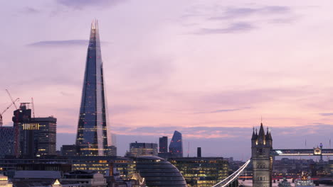 Prominent-landmarks-of-The-Shard-and-Tower-Bridge-at-twilight-in-London,-aerial