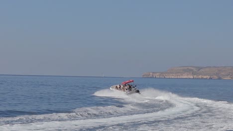 A-touristic-boat-glides-along-the-coastline-of-Malta,-embodying-the-spirit-of-travel,-exploration,-and-adventure