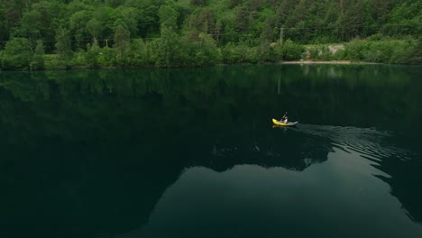 Kayaker-in-deep-lake-of-Norway,-aerial-view