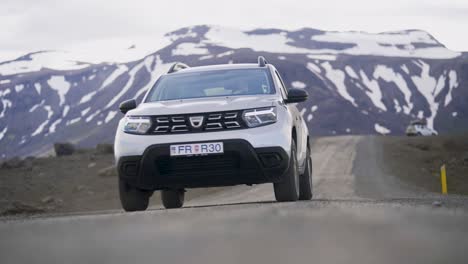 SUV-vehicle-driving-towards-camera-in-snowy-landscape-of-Iceland