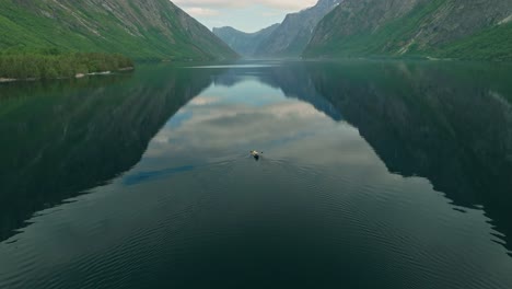 Kayak-in-middle-on-massive-Norway-lake,-aerial-view