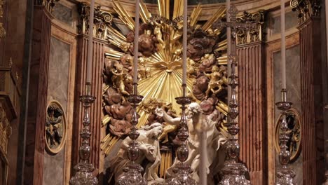 A-tilt-down-shot-of-the-Baptism-of-Jesus-with-chandeliers-in-the-foreground-in-Saint-John's-Co-Cathedral