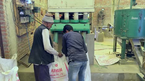 Hombre-Cambiando-El-Saco,-Mientras-Se-Llenaba-Con-Arroz-Molido.