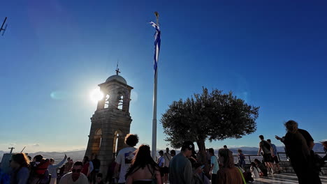 Waving-Greek-flag-and-many-tourists-of-top-of-Lycabettus-hill
