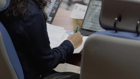 Executive-woman-taking-notes-during-a-meeting