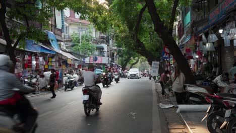 Sunlight-filters-through-lush-trees-in-Hanoi's-old-town,-creating-a-serene-urban-scene