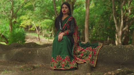 Dressed-in-traditional-Indian-wear,-a-young-girl-enjoys-her-day-at-a-tropical-park-in-the-Caribbean