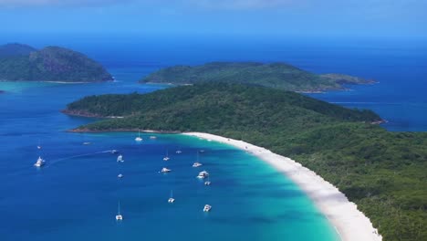 Whitehaven-Beach-sailboat-yachts-sunny-mid-day-summer-aerial-drone-picturesque-sandy-reef-Whitsundays-Islands-North-end-Hill-Inlet-Lookout-Aussie-National-Park-scenic-flight-view-circle-left-motion