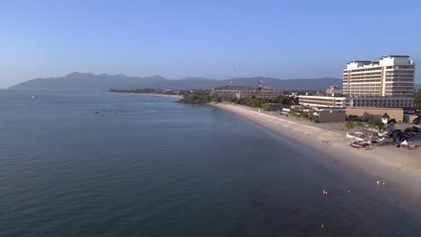 Langkawi-coastline-showing-hotels-and-resorts-on-a-tropical-beach-with-tourists-enjoying-the-clear-blue-water