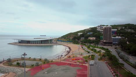 APEC-Haus-convention-center-Ela-Beach-Papua-New-Guinea-aerial-drone-morning-cloudy-sunrise-PNG-Crown-Hotel-Plaza-Hilton-Port-Moresby-Harbour-Marina-Walter-Bay-Coral-Sea-coastline-capital-city-upward