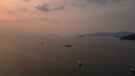 Tropischer-Strand-Mit-Traditionellen-Longtail-Booten-Bei-Orangefarbenem-Sonnenuntergang-Auf-Koh-Lipe,-Der-Eine-Ruhige-Und-Malerische-Atmosphäre-Schafft