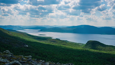 Timelapse-of-cloud-shadows-moving-over-lake-Kilpisjarvi,-summer-day-in-Lapland