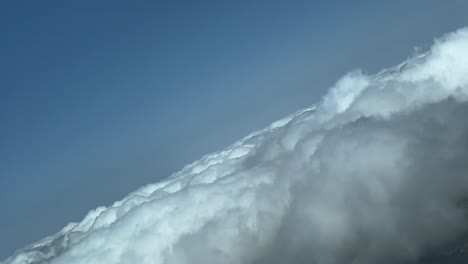 Pilot-POV-in-an-abrupt-right-turn-over-a-layer-of-cumulus-clouds-in-a-sunny-day