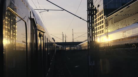 Outside-the-window-shot-of-Berlin's-busy-train-tracks-during-sunrise
