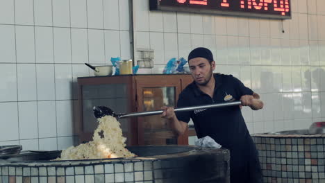 Chef-De-Uzbekistán-Cocinando-Arroz-Plov-En-Cámara-Lenta-En-Horno-Encendido