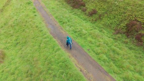 Rear-drone-view-of-tourist-exploring-Peak-District-National-Park-in-Derbyshire,-England