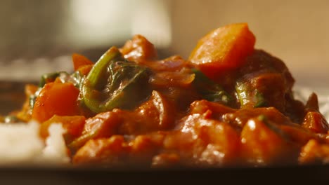 Traditional-Indian-Cuisine-Food-Vegetable-Tikka-Masala-Curry-with-Steam-Rising-from-Rice-in-a-Bowl---4K-Close-Up-High-Quality-Footage