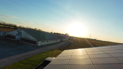 Reflecting-sunlight-on-solar-panels-installed-on-top-of-barn-building-during-golden-sunset