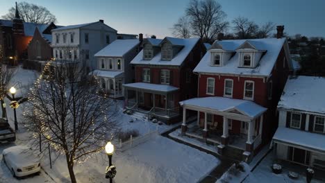 Snowy-housing-area-in-american-neighborhood-with-snow-covered-porch-at-dusk