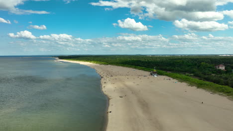 Aerial-view-of-Stogi-Beach-in-Gdansk-with-a-sandy-shore-and-forested-background