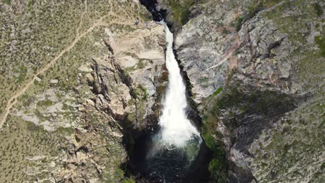 Aerial-view-of-waterfall-in-wild-rocky-environment