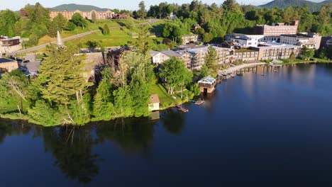 Aerial-view-of-the-shore-of-Mirror-Lake-with-hotels-in-Lake-Placid,-New-York