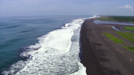Aerial-shot,-passing-by-on-top-of-the-volcanic-sand-beaches-of-monterrico-in-Guatemala