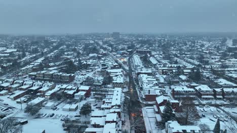 Snowy-flurries-falling-from-sky-covering-american-town-in-winter