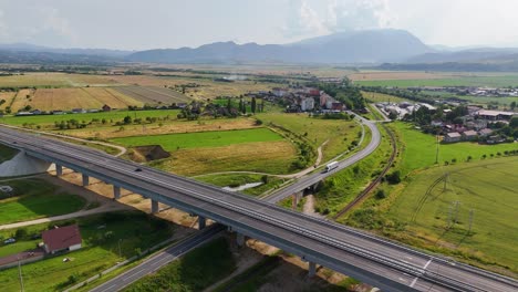 Highway-over-road-near-Rasnov,-scenic-fields-and-mountains