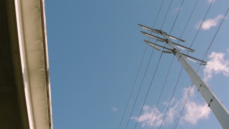 Low-angle-view-of-Utility-pole-as-clouds-passes-over