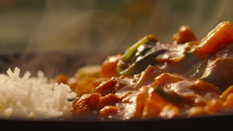 Ultra-Slow-Motion-Footage-of-Indian-Food-Vegetable-Tikka-Masala-Curry-with-Basmati-Rice-Steam-Rising---4K-Shallow-Depth-of-Field-Footage