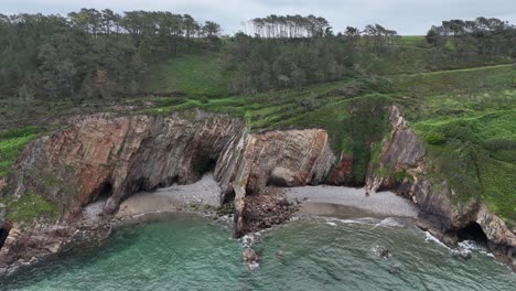 Rocky-shore-with-sea-caves-near-Cueva,-beach-Spain-drone,aerial