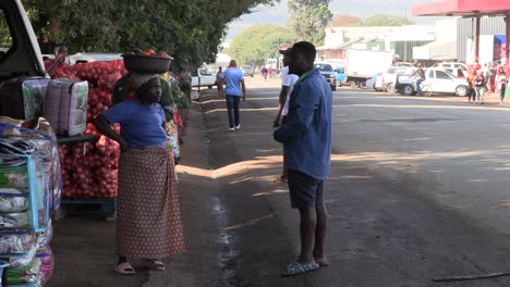 African-people-on-a-bustling-street,-talking,-carrying-baskets-and-walking