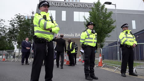 A-cordon-of-police-officers-stand-in-line-at-the-entrance-to-an-Intercontinental-Hotel-during-a-public-order-incident