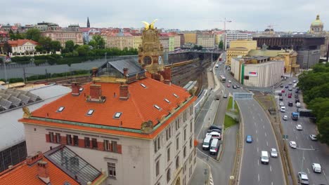 Main-train-station-Prague,-Czech-Republic,-featuring-a-historic-building-with-a-clock-tower,-roads,-and-cityscape