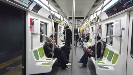 Argentine-people-travel-inside-white-light-green-underground-train-wagon-south-american-capital,-Buenos-Aires-City