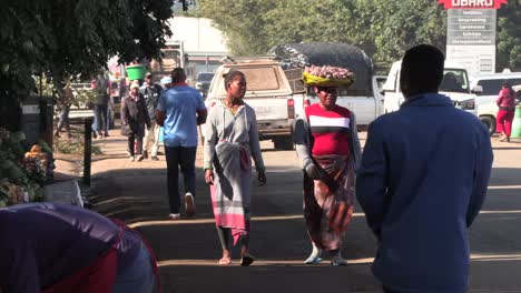 African-people-on-a-bustling-street,-carrying-baskets-and-walking