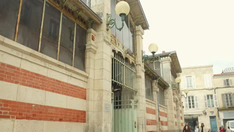 Tilt-shot-of-historic-landmark-and-food-market---Les-Halles-in-La-Rochelle,-France