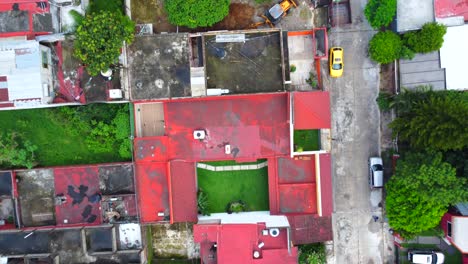 aerial-view-from-a-drone-of-the-heavy-machinery-work-in-the-inner-courtyard-of-a-house-on-the-city-of-Cordoba,-Veracruz,-Mexico