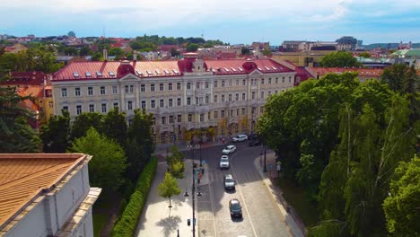 Historic-building-in-Vilnius,-Lithuania,-with-red-rooftops-and-surrounding-trees