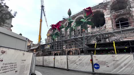 Entering-renovation-area-at-the-back-of-the-Arena-with-lots-of-strange-sculptures-stored-there-and-scaffolding-in-Verona,-Italy