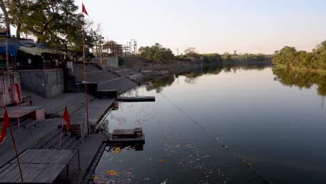 religious-holy-riverbank-with-flowers-and-religious-waste-at-morning